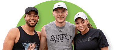 Three individuals smiling and posing for a photo at an athletic event.