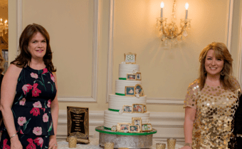 two women with large cake