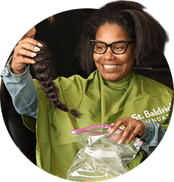 Guy smiling after having his head shaved