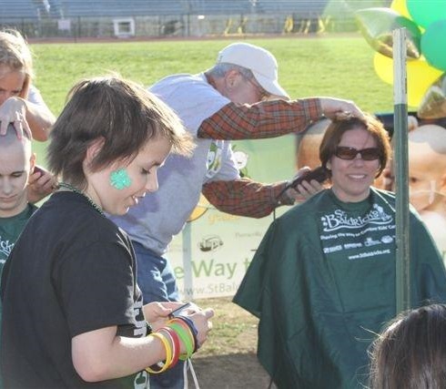 David and Susan shaving her head to help fund pediatric cancer research