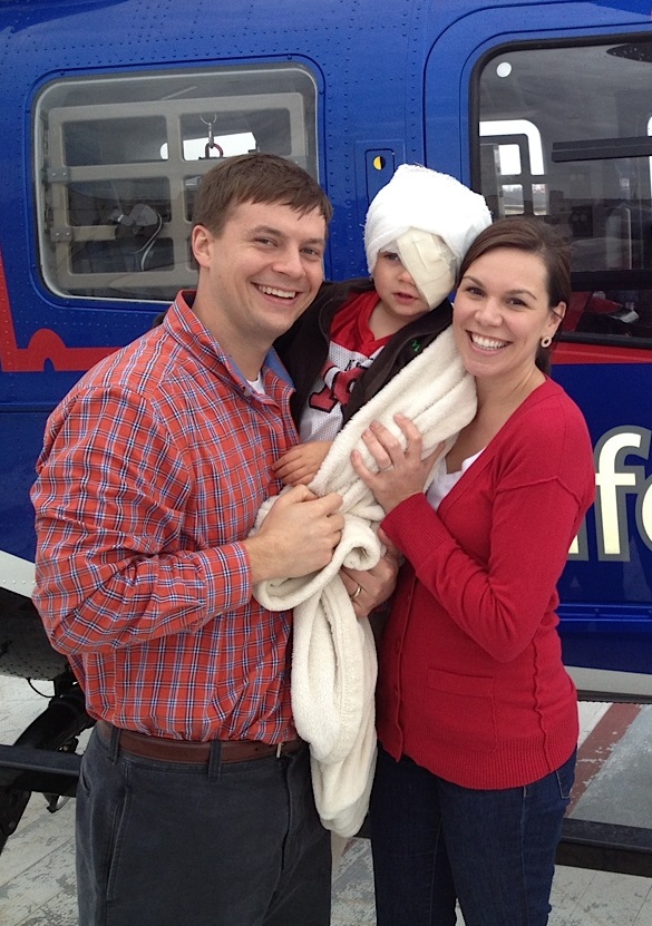 Sammy with head bandage after procedure for pediatric cancer