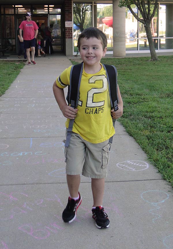 Hayden in front of his school