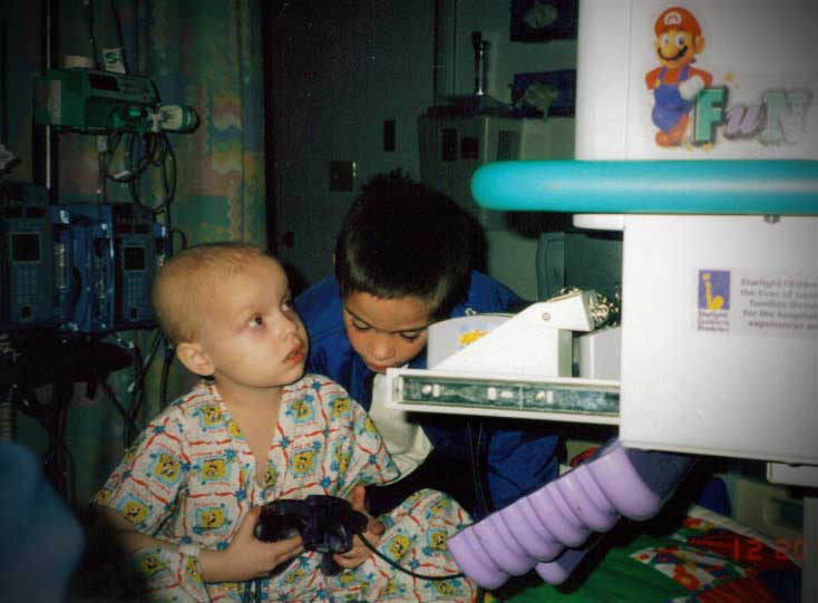 William playing video games in his hospital bed