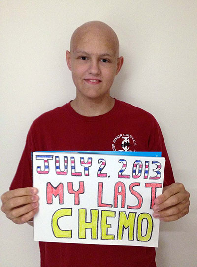 Brian holding a sign commemorating his last day of chemo