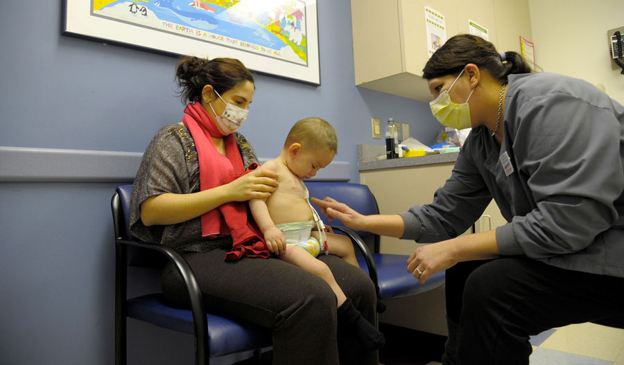 Kelly Clickner, R.N., assisting a pediatric oncology patient at Albany Medical Center