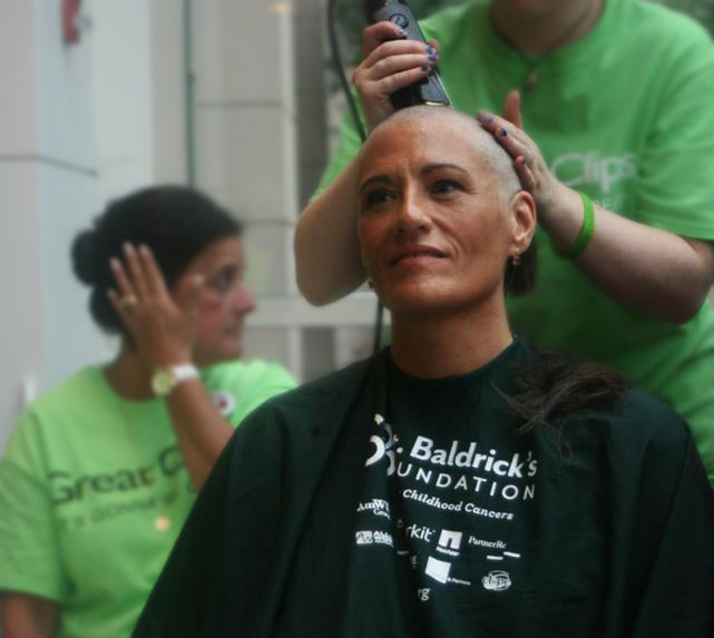 Leslie getting her head shave at the 46 Mommas Shave for the Brave