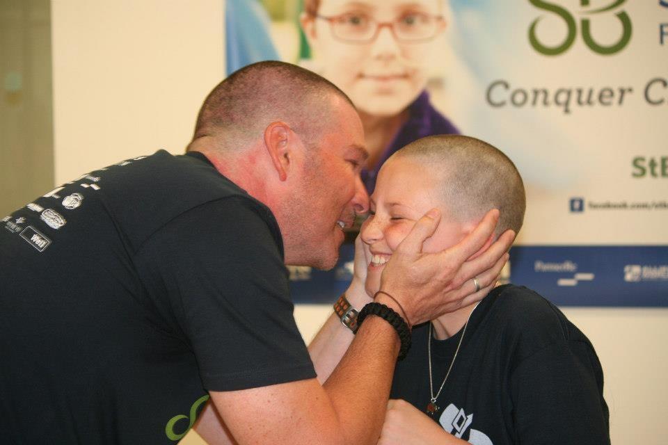 Father and daughter after shaving heads for cancer