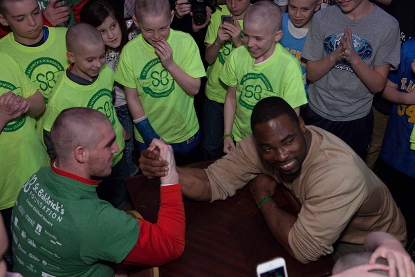 Justin Tuck arm at a St. Baldrick's head-shaving event