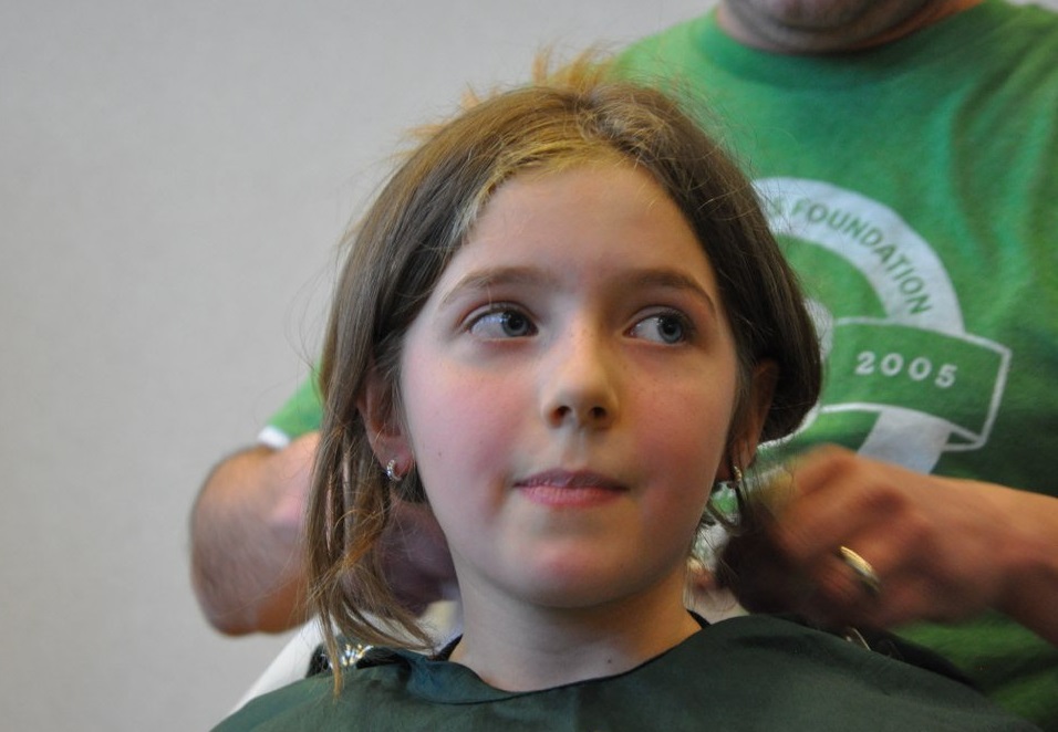 Girl smiles nervously as she prepares to shave