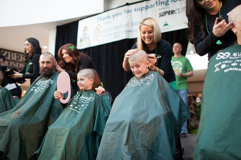 Kaela, Mara, and their dad getting their heads shaved