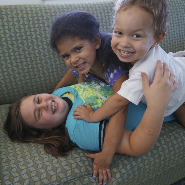 Carolyn and Rebecca playing with their little brother, Joshua