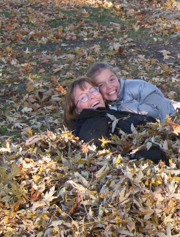 Jessica and her mom in a pile of leaves