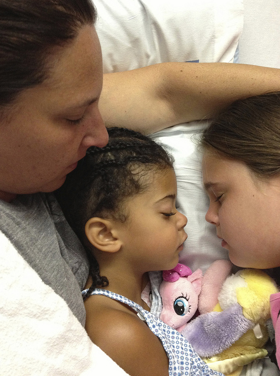 Carolyn and Rebecca sleeping in a hospital bed