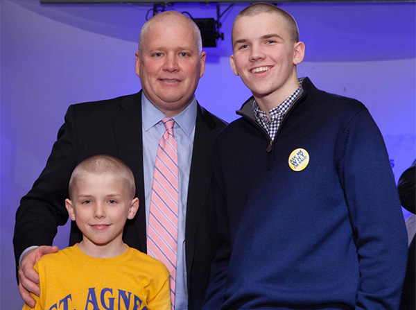 Liam Hogan with brother Aiden and dad Bill after shaving their heads to help kids with cancer