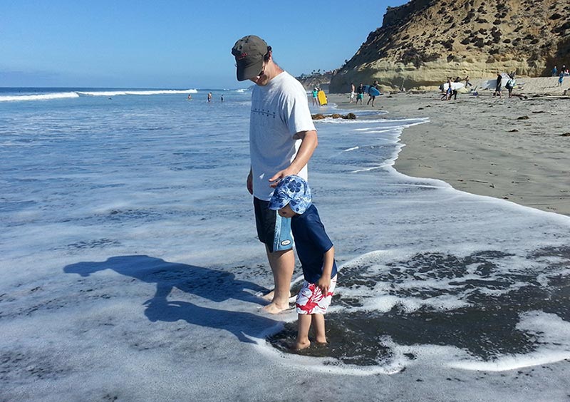 Micah and his dad at the beach