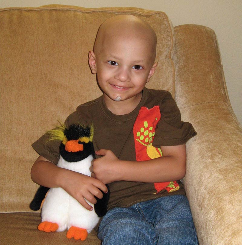 Micah holding a stuffed penguin