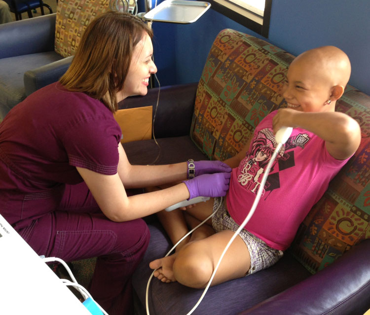 A nurse at the Vannie Cook clinic in McAllen, Texas, laughs with Alma, a patient there who has now finished treatment.