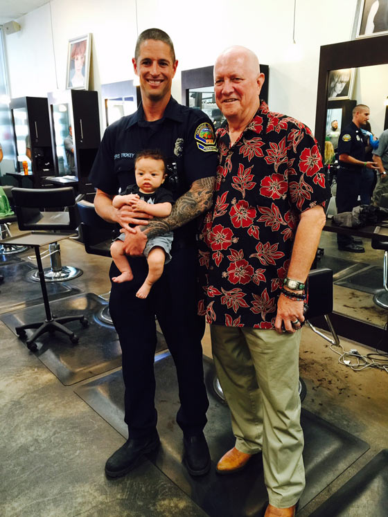 Dr. Michael Shannon stands with Chris Trokey and his son Porter at a St. Baldrick's head-shaving event.
