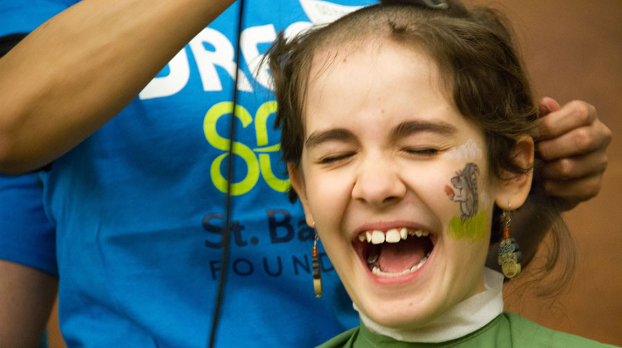 Ivy Moore shaves for her sister, Georgia, who had acute lymphoblastic leukemia.