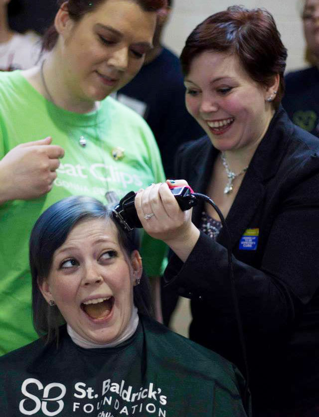 Katherine, Carolyn's twin, helps shave their younger sister's head for St. Baldrick's.