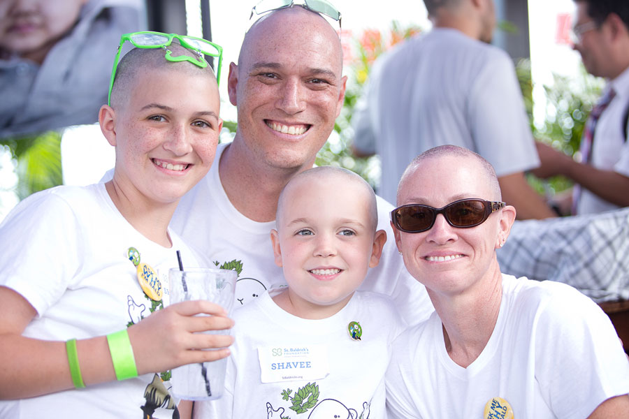 Jeremy Edwards smiles with his wife and two kids after they all shaved for St. Baldrick's