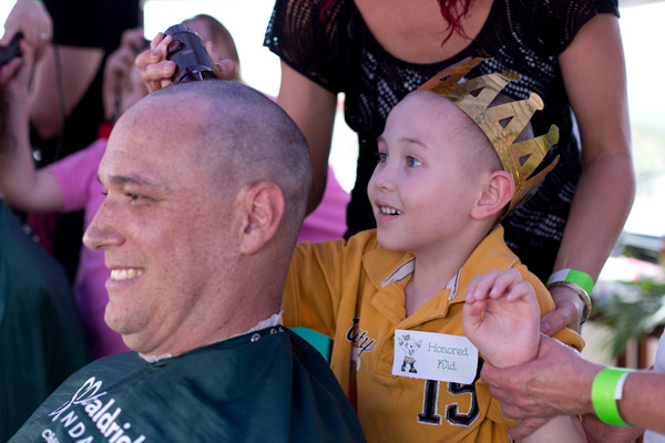 Jeremy getting shaved by a St. Baldrick's Honored Kid