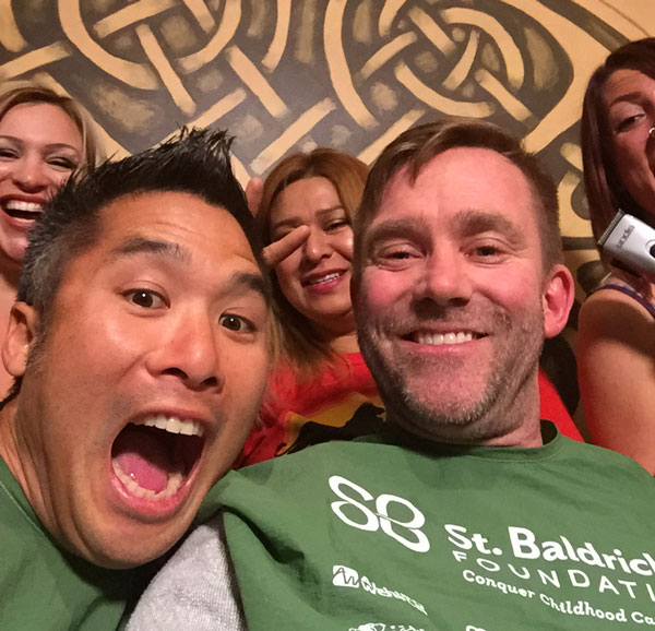 Robb poses for a group selfie at the McMullan's Irish Pub St. Baldrick's event
