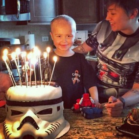 Carter waits to blow out the candles on a stormtrooper-shaped cake