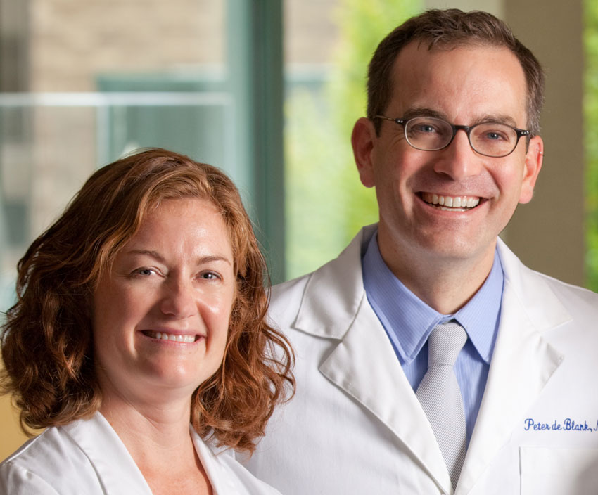 Dr. Peter de Blank and his wife Dr. Robin Norris in their lab coats