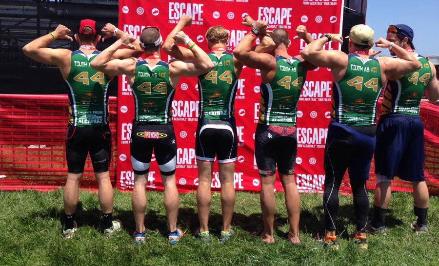 Ace's friends flex in their Tough as Ace jerseys bearing Ace's football jersey number at the Escape from Alcatraz Triathlon