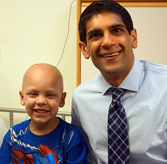 Dr. Rishi Lulla with a childhood cancer patient