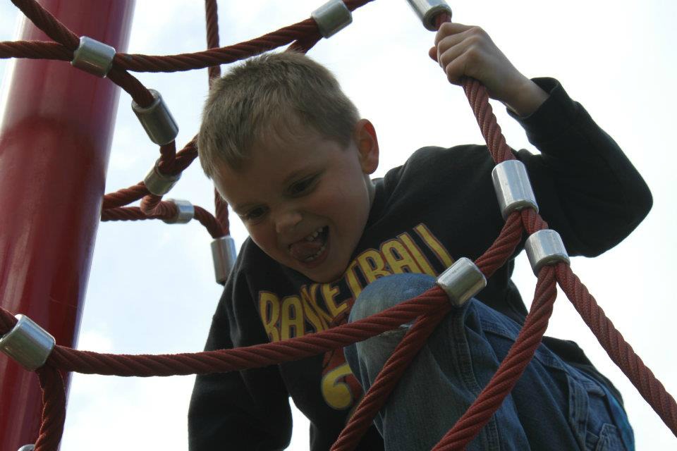 Jeremy climbs playground equipment