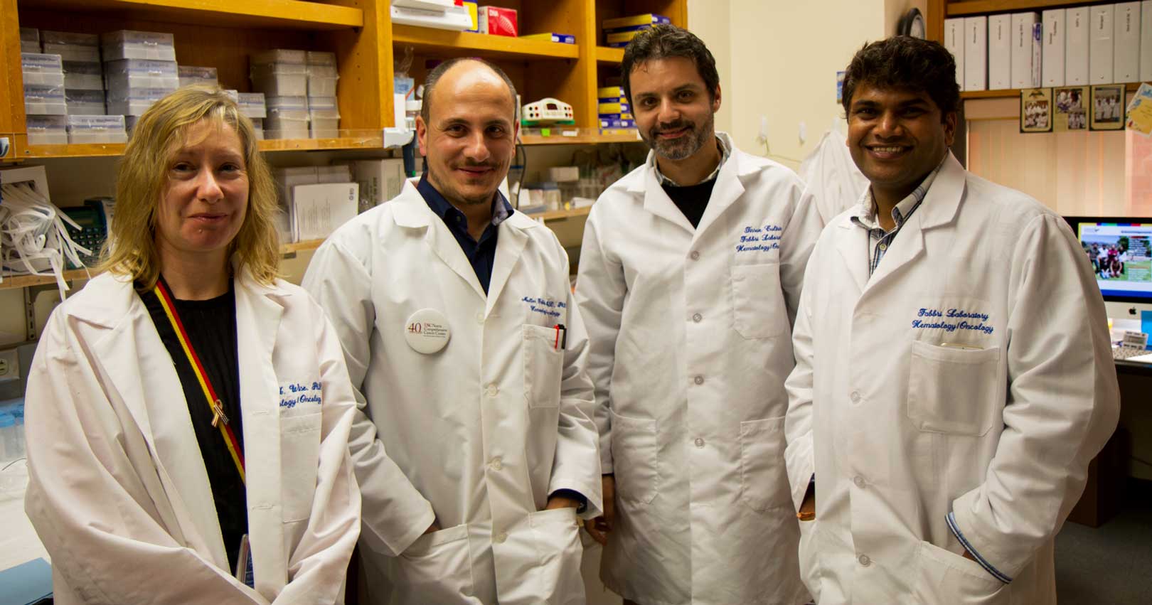 Dr. Fabbri and his colleagues stand together for a photo in the lab