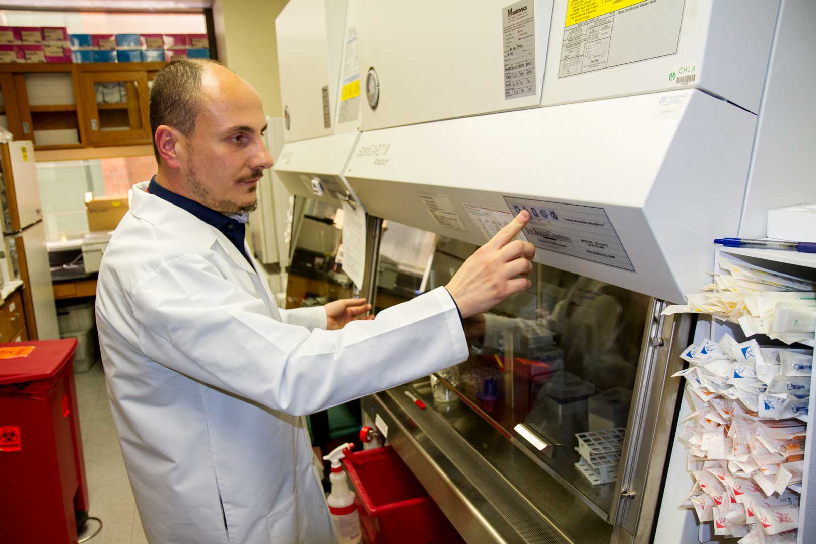 Dr. Fabbri presses buttons on a hood in his lab