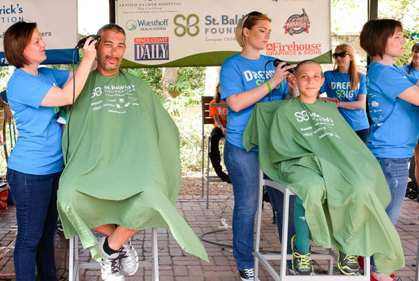 Greg and his son Jaxon shave during a St. Baldrick's event