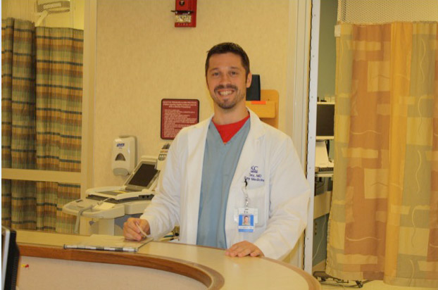Ted Sibley, M.D., smiles in a lab coat