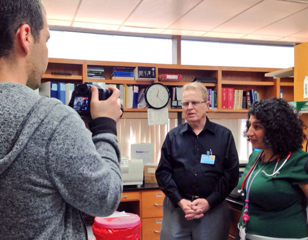 Dr. Seeger answers questions for our camera during our visit to his lab