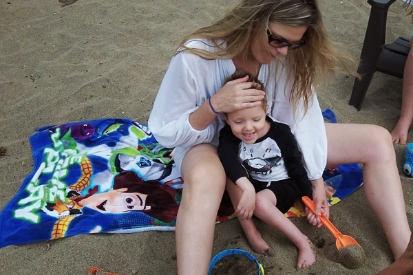 Cindy holding Ty on the beach