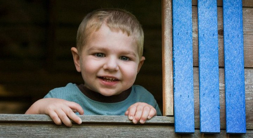 Ben smiles as he looks out a window.