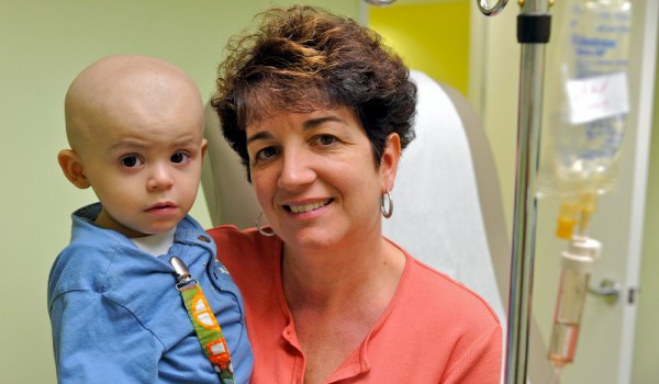 Pediatric oncology nurse Ginny Escobedo with a young patient.