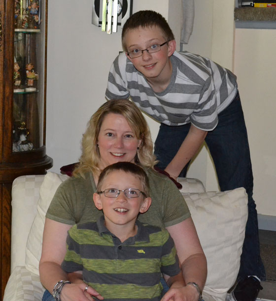 Lori sits with her two sons.