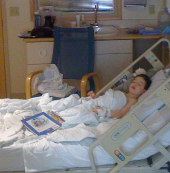 Austin sleeping in a hospital bed