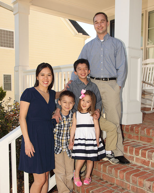 Nancy smiles with her husband and three children