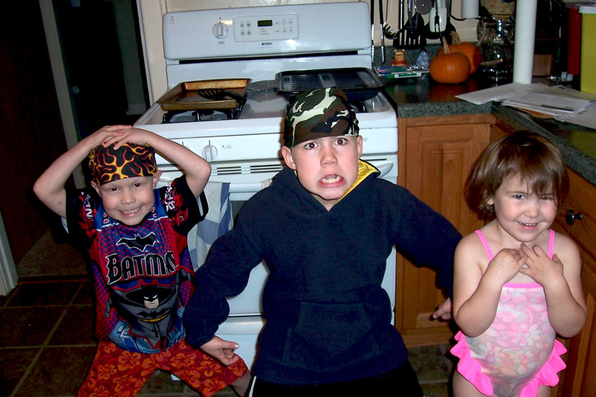 Joey plays with his siblings in the kitchen