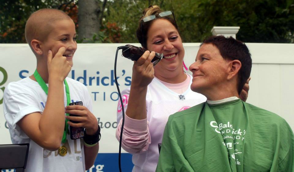 Daphne smiles after taking the first swipe at her mom's hair with the clippers