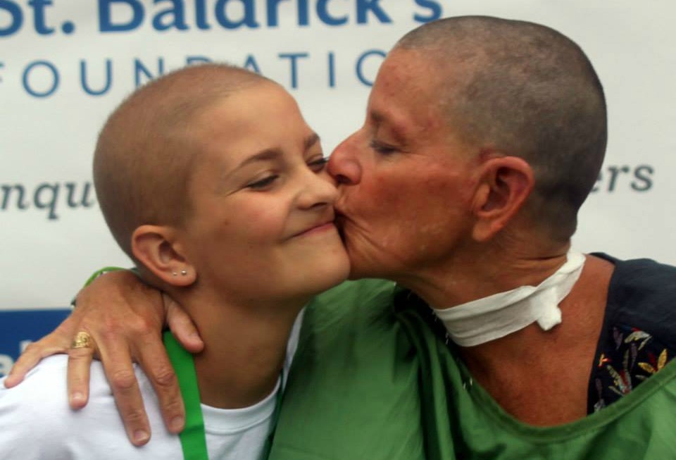 Liz kisses her daughter on the cheek after her shave with St. Baldrick's