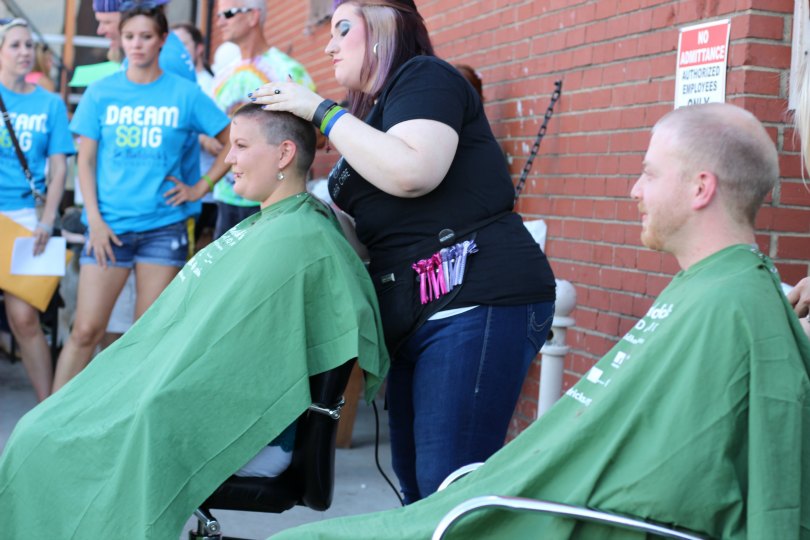 Caleb watches Ashlee brave the shave from his barber's chair