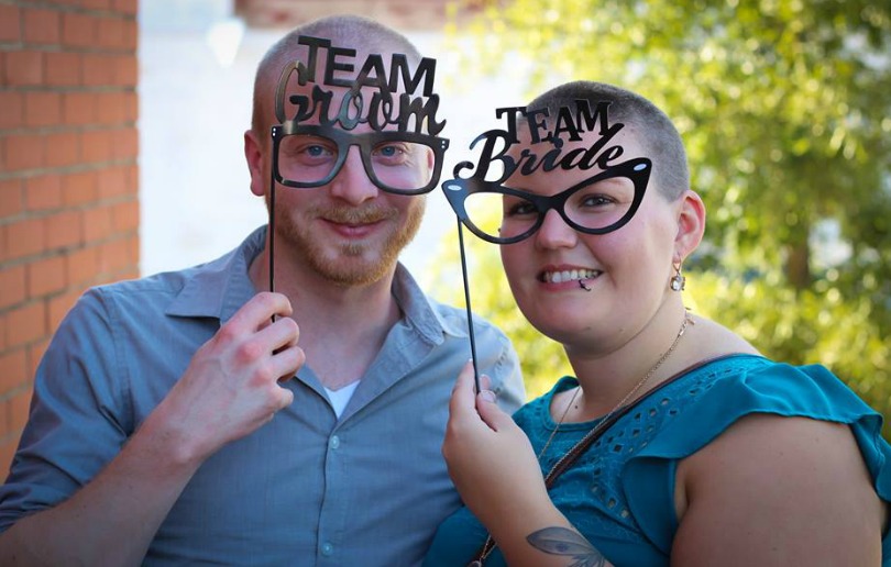 Caleb and Ashlee sport glasses that say 'Team Groom' and 'Team Bride'