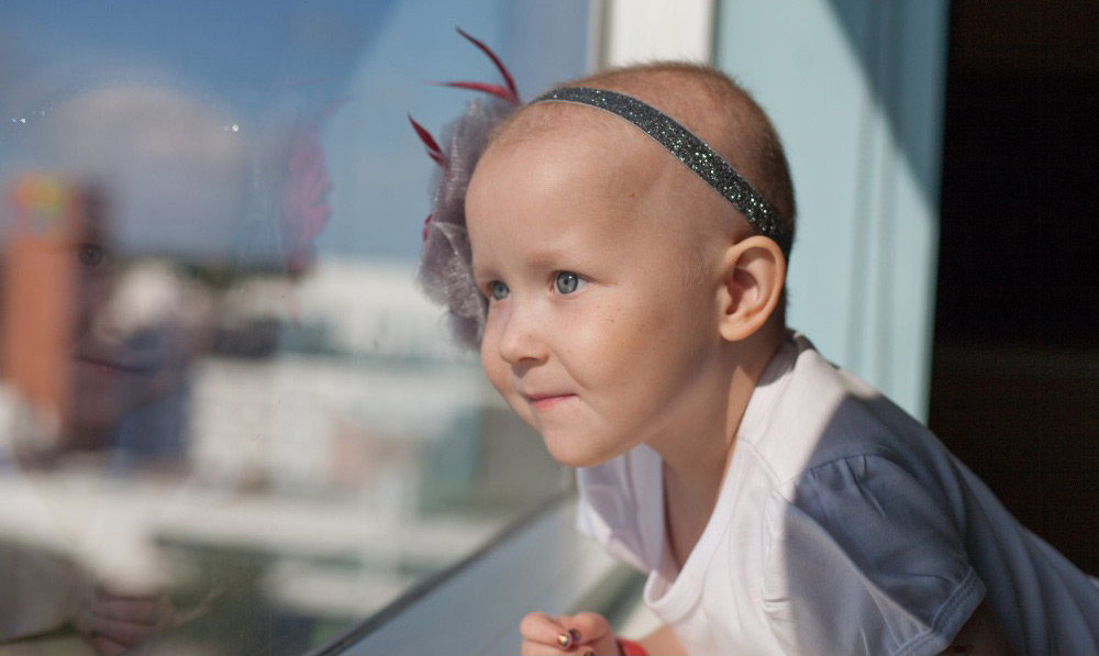 Chloe stares out of a hospital room window