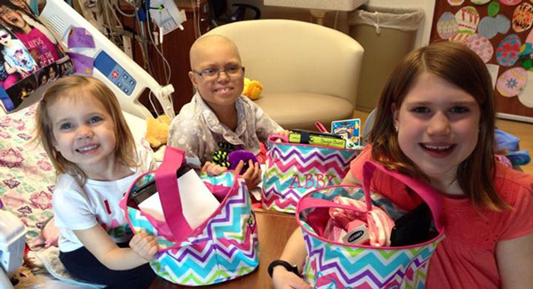 Abby and her sisters in her hospital room